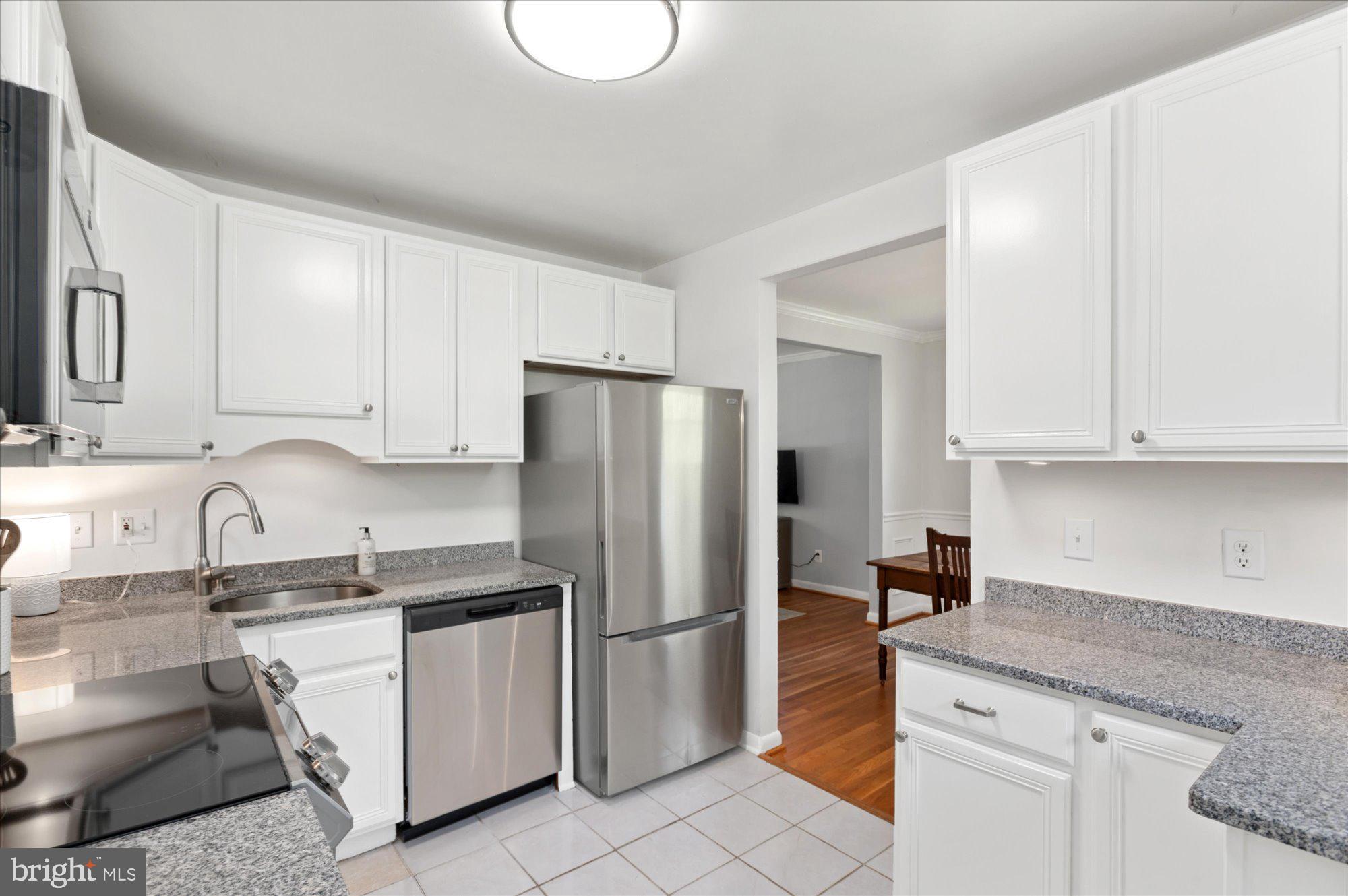 11201 Lombardy Road Silver Spring, MD 20901 - Photo 8 of 31 a kitchen with white cabinets and refrigerator