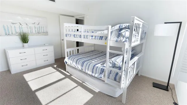 a bedroom with a bed a couch and dresser