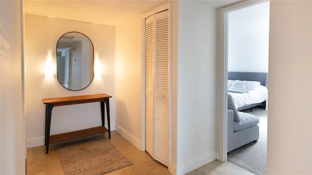 a room with painting on the wall and a potted plant