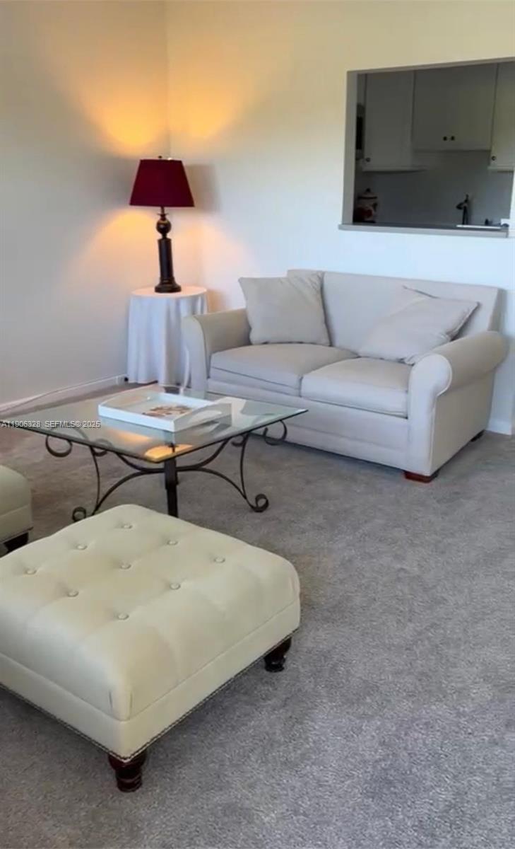 22 Brighton A, Unit 22 Boca Raton, FL 33434 - Photo 3 of 3 a living room with furniture and a lamp