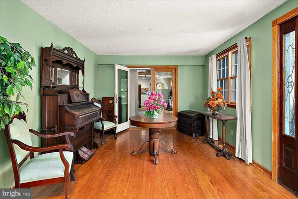a kitchen that has a lot of cabinets in it and wooden floors