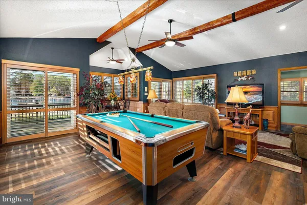 a living room with furniture ceiling fan and a window