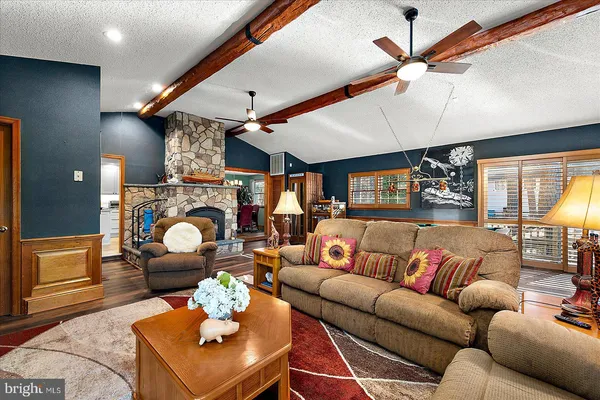 a view of hallway with stairs and a wooden floor