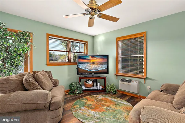 a view of a dining room with furniture large windows and wooden floor