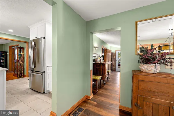 a view of an ocean with boats and trees in the background