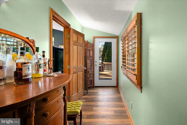 a view of a balcony with wooden floor and outdoor seating