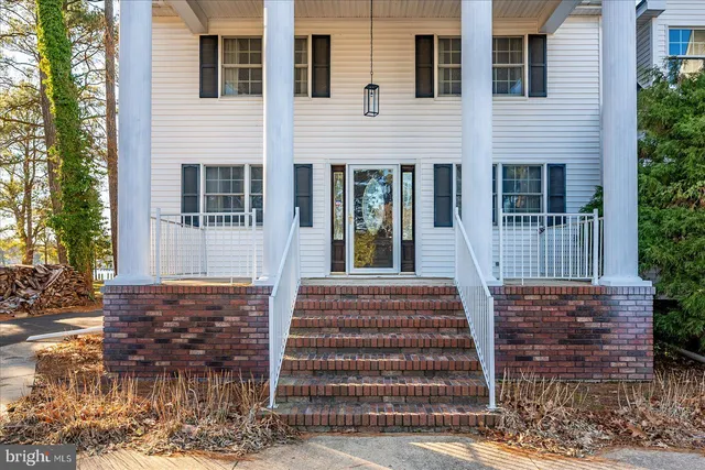 a living room with furniture a ceiling fan and a window