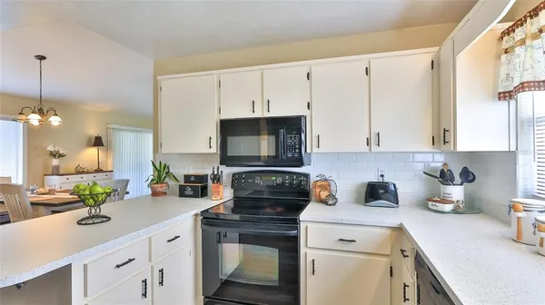 a kitchen with a sink a stove and cabinets