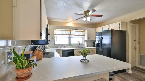 a large kitchen with a table and chairs