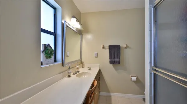 a bathroom with a sink a mirror and a window