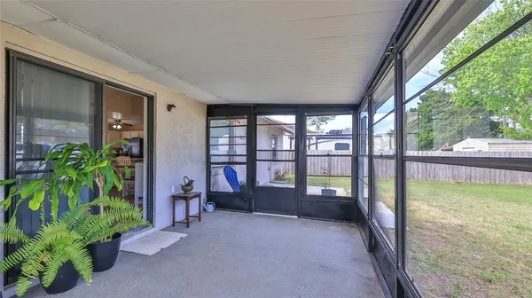 a very nice looking room with a large window and potted plants