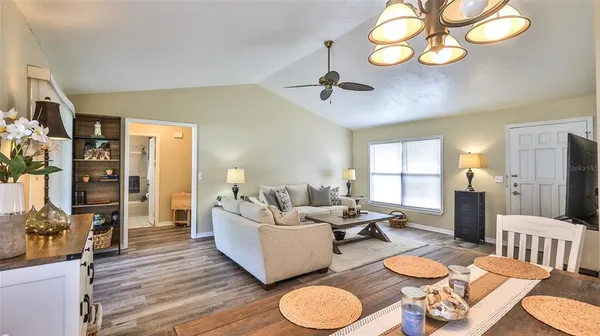a living room with furniture chandelier and a window