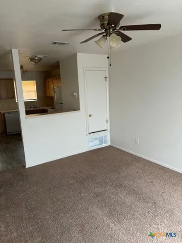 a view of a kitchen with a sink and a refrigerator