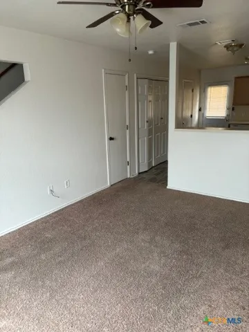 a view of a hallway with a kitchen