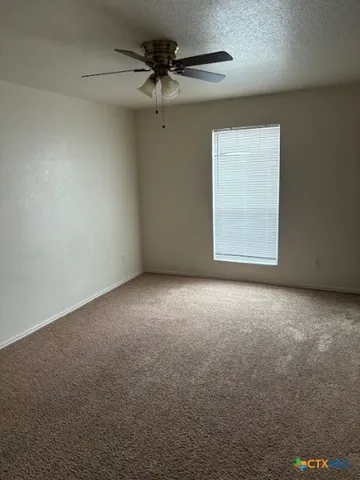 an empty room with a empty space and a ceiling fan