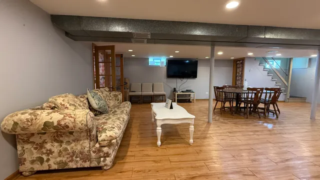 a living room with furniture a projector and a flat screen tv