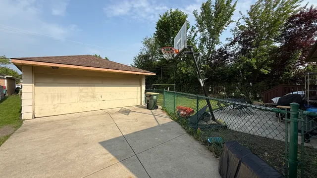a view of a swimming pool with a patio and a yard