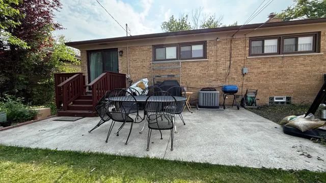 a view of house with backyard and patio