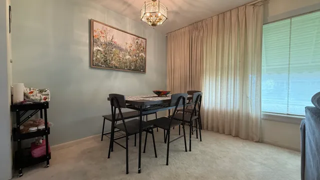 a dining room with furniture and window