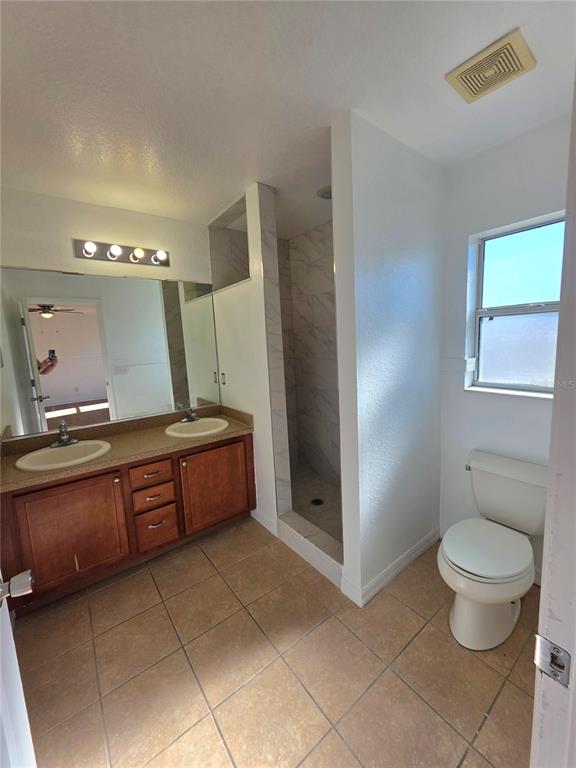 12 Juniper Loop Drive Ocala, FL 34480 - Photo 7 of 14 a spacious bathroom with a granite countertop sink a toilet and a mirror