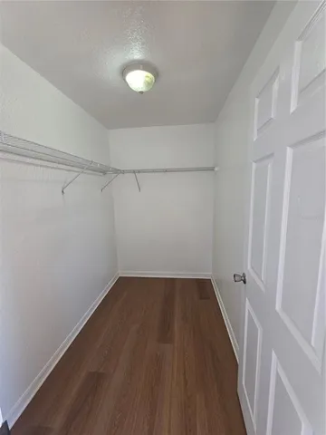 a view of a room with wooden floor