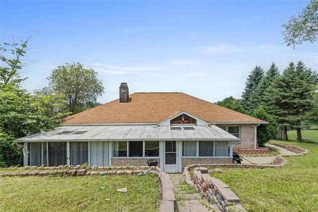 a view of a house with backyard sitting area and garden
