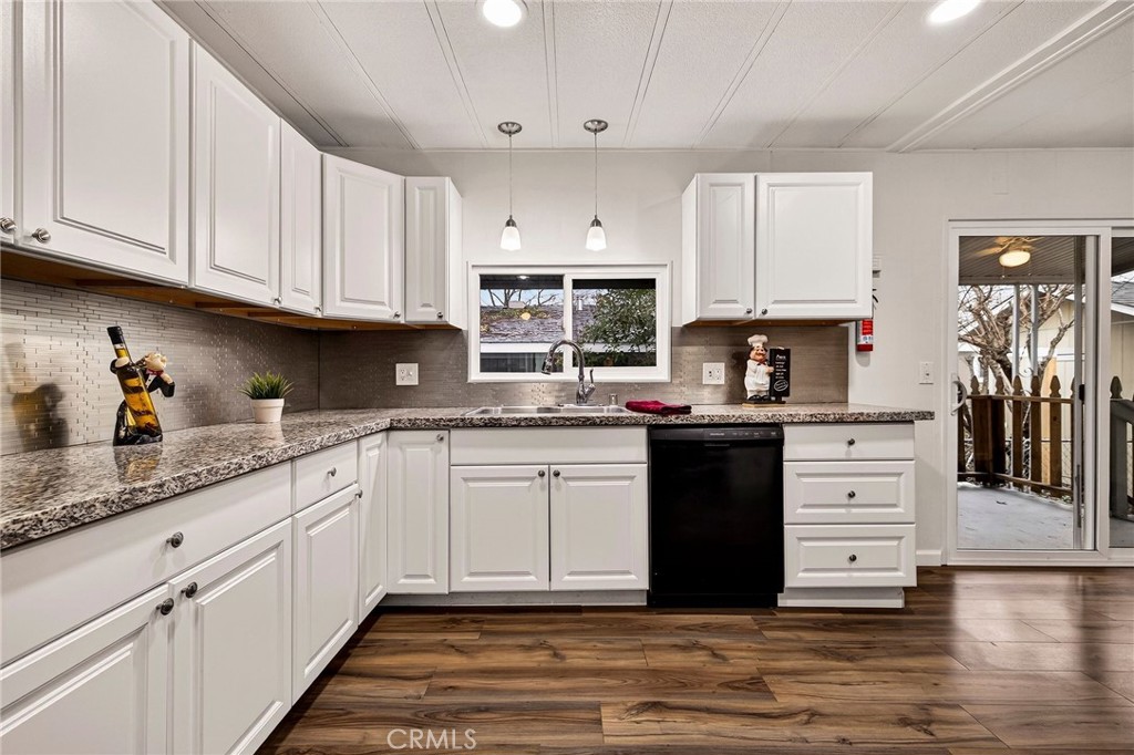 3548 Vía Medio Chico, CA 95973 - Photo 11 of 48 a kitchen with granite countertop white cabinets and stainless steel appliances