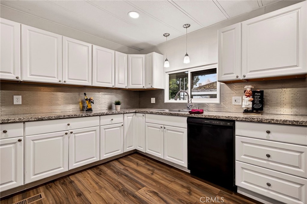 3548 Vía Medio Chico, CA 95973 - Photo 12 of 48 a kitchen with granite countertop white cabinets and white appliances