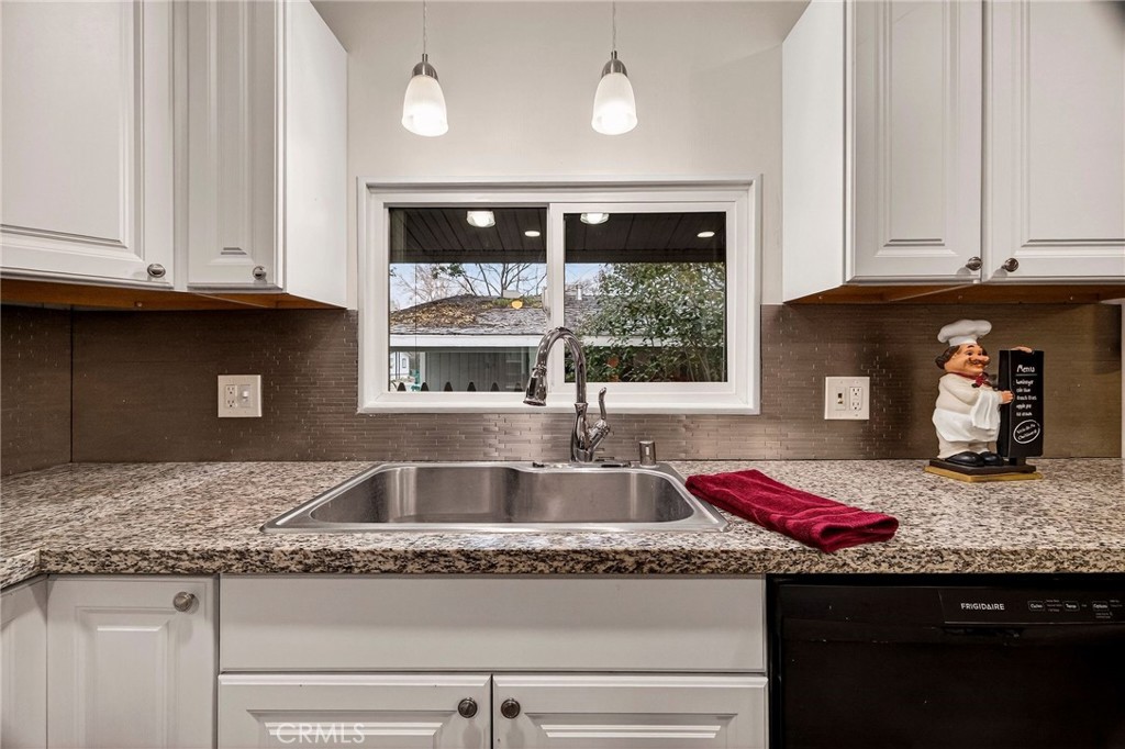 3548 Vía Medio Chico, CA 95973 - Photo 14 of 48 a kitchen with granite countertop a sink dishwasher and cabinets