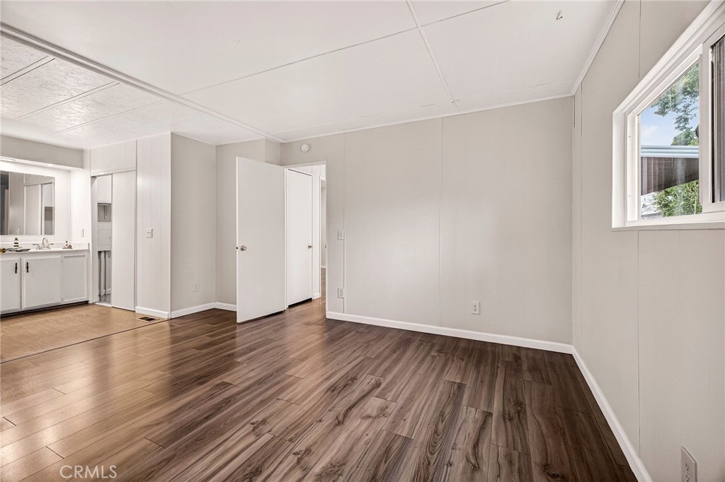 3548 Vía Medio Chico, CA 95973 - Photo 16 of 48 a view of an empty room with window and wooden floor