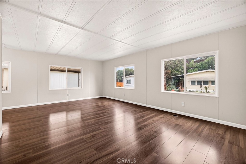 3548 Vía Medio Chico, CA 95973 - Photo 6 of 48 a view of an empty room with wooden floor and a window