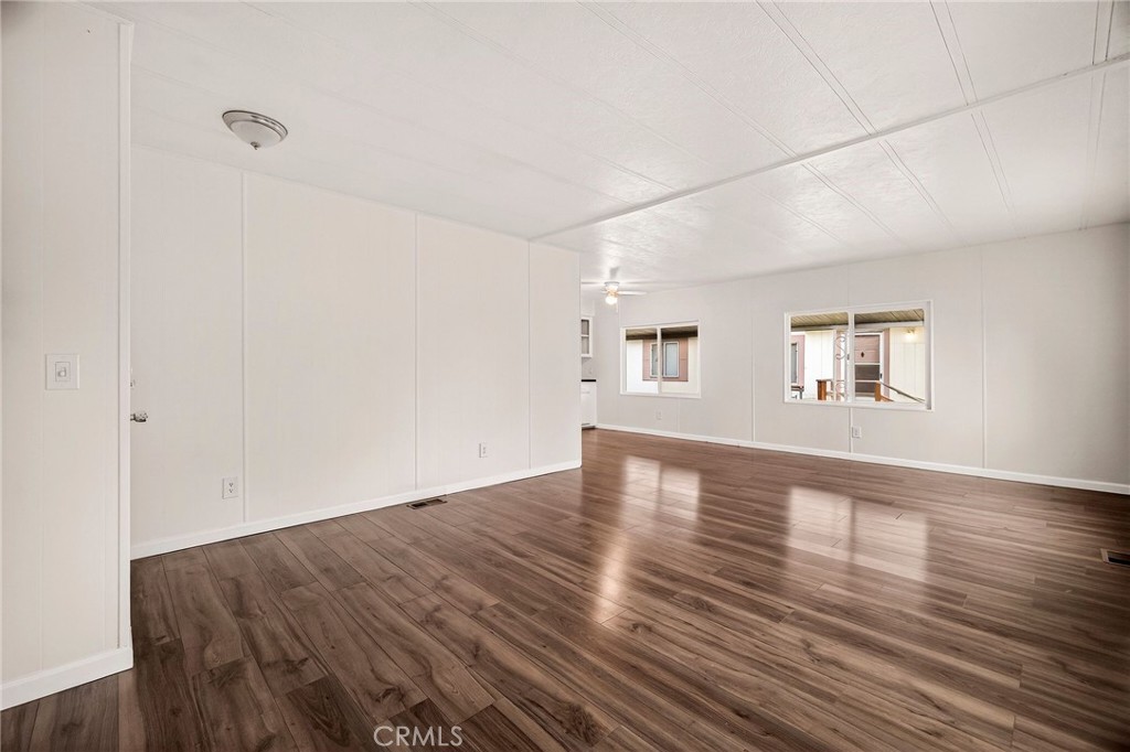 3548 Vía Medio Chico, CA 95973 - Photo 7 of 48 an empty room with wooden floor and windows