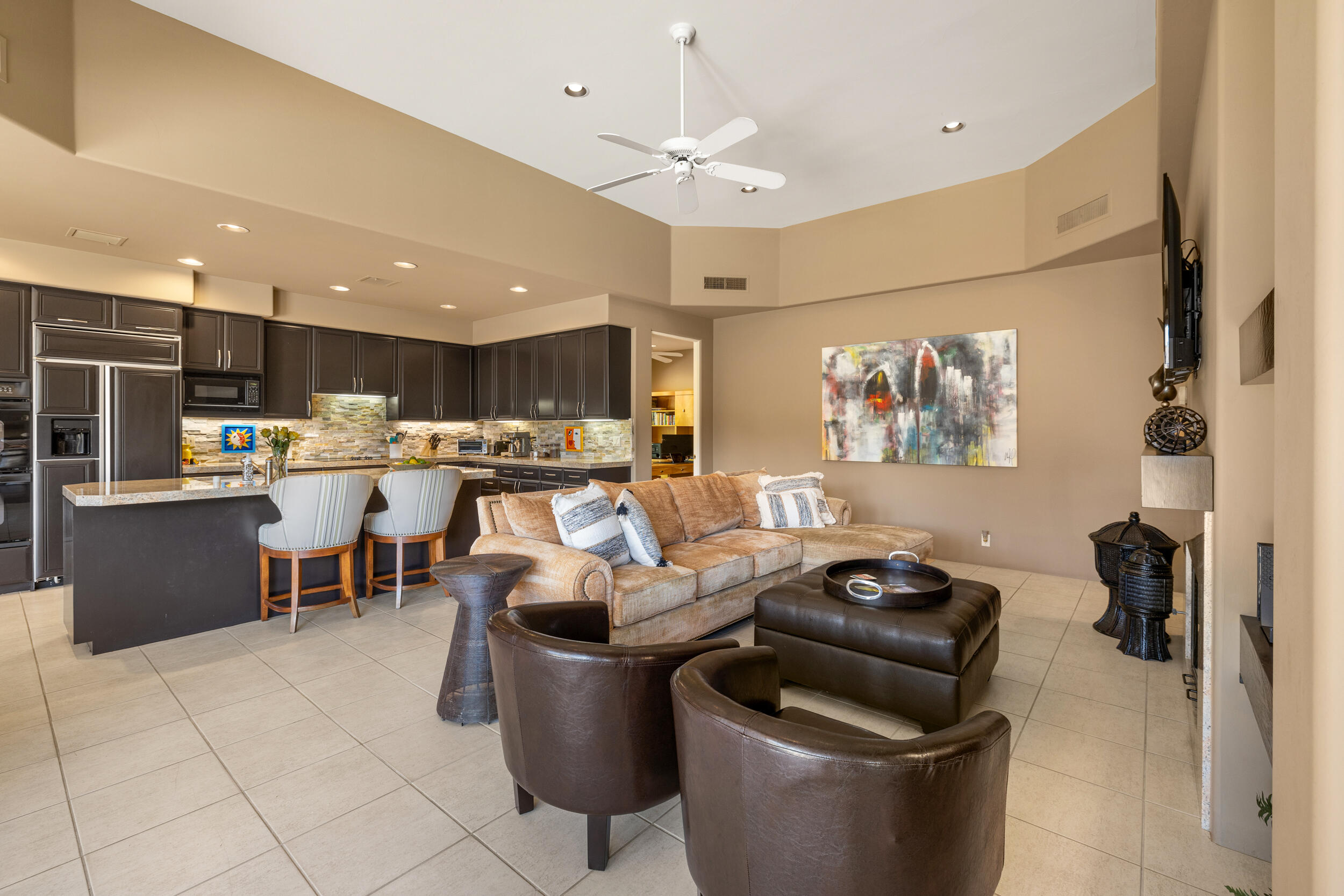 50445 Mountain Shadows Road La Quinta, CA 92253 - Photo 14 of 33 a living room with lots of furniture and kitchen view