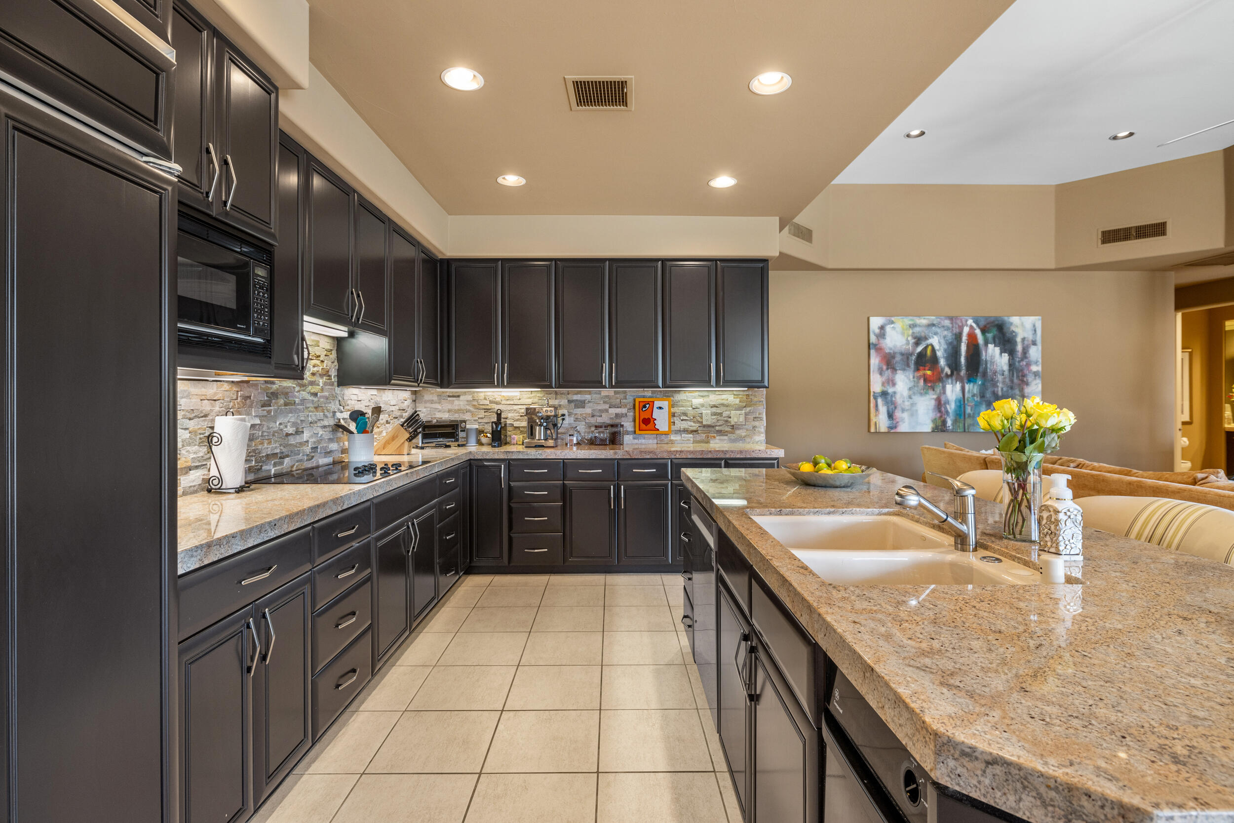 50445 Mountain Shadows Road La Quinta, CA 92253 - Photo 15 of 33 a kitchen with stainless steel appliances granite countertop sink stove top oven and cabinets