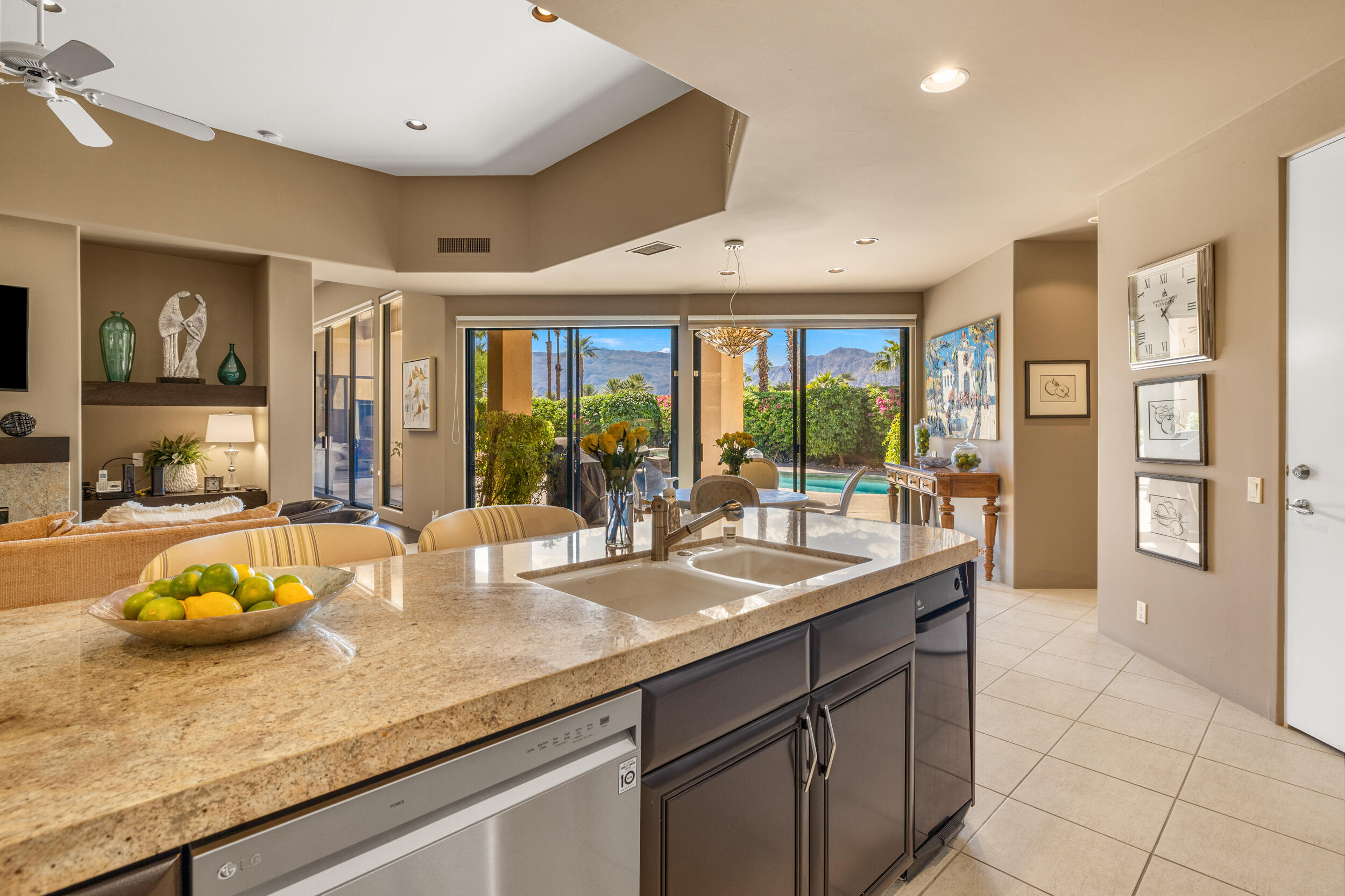 50445 Mountain Shadows Road La Quinta, CA 92253 - Photo 17 of 33 a kitchen with a sink and living room