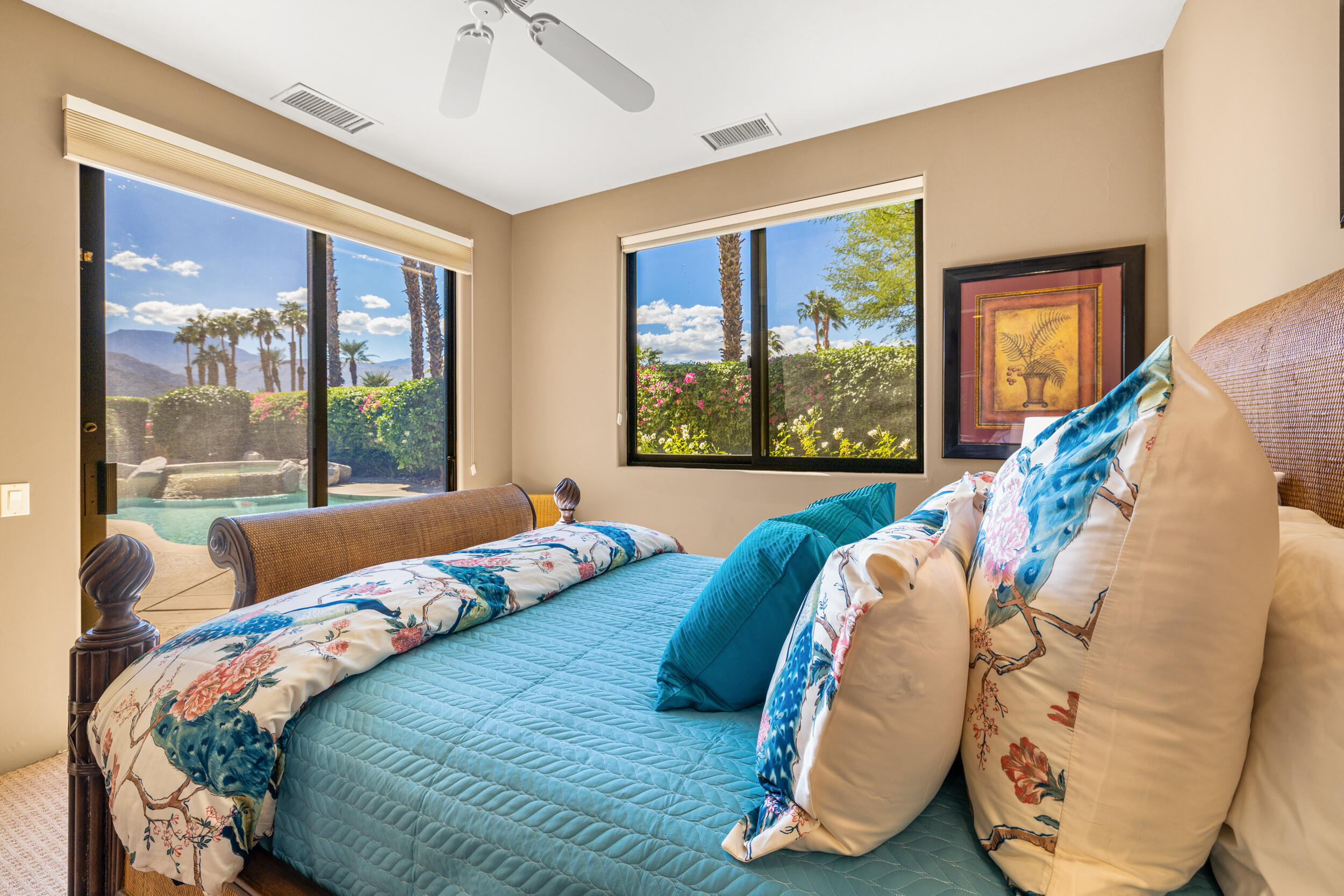50445 Mountain Shadows Road La Quinta, CA 92253 - Photo 22 of 33 a bedroom with a bed and glass windows