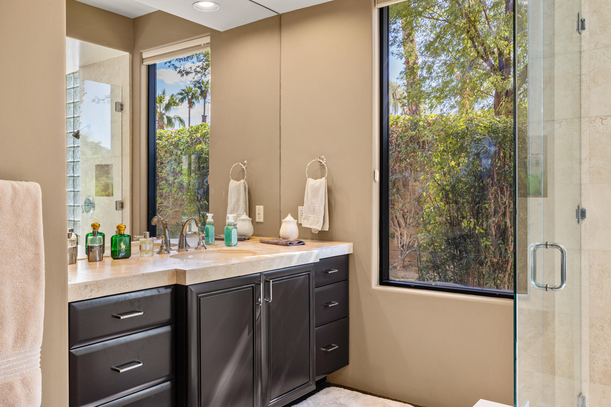 50445 Mountain Shadows Road La Quinta, CA 92253 - Photo 26 of 33 a bathroom with a sink and a mirror