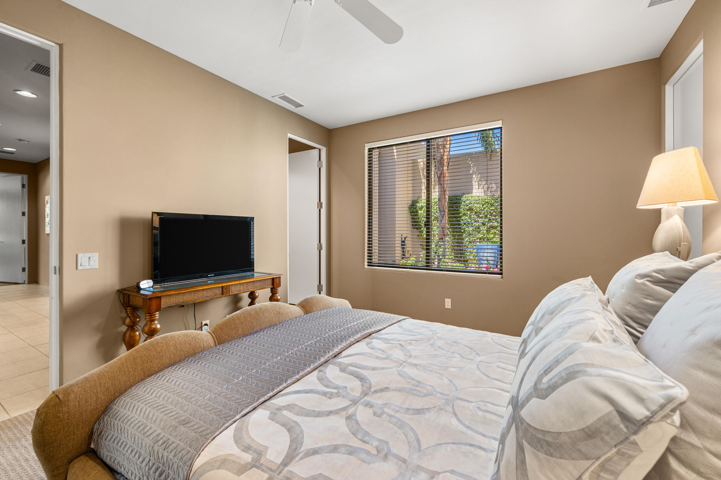 50445 Mountain Shadows Road La Quinta, CA 92253 - Photo 27 of 33 a bedroom with a bed and a flat screen tv