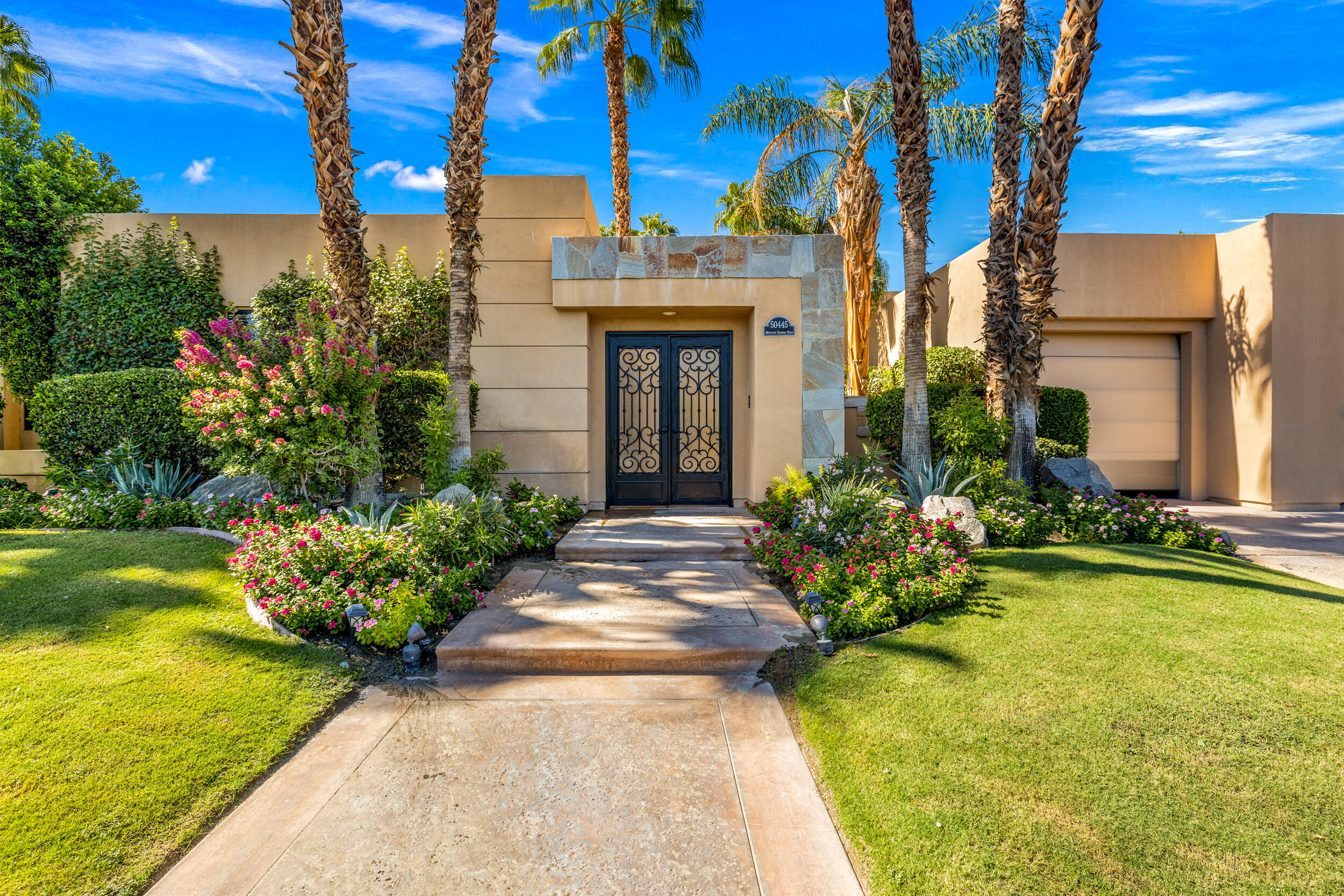 50445 Mountain Shadows Road La Quinta, CA 92253 - Photo 4 of 33 a view of a house with a yard and potted plants