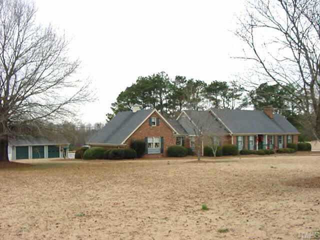915 White Memorial Church Road Willow Spring, NC 27592 - Photo 1 of 1 Gorgeous quality built all brick home with huge screened porch, deck, 2-car garage plus 3 detached garages on awesome 3 acre lot with a pond view! Spacious concrete parking pad. Exterior Front