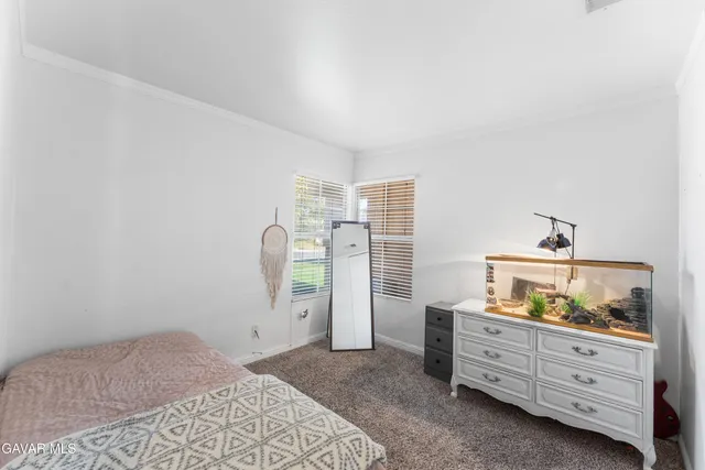 a bed room with a bed and a dresser