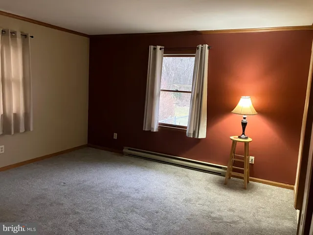 an empty room with windows and closet