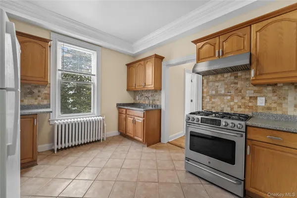 a kitchen with a stove a sink and a microwave