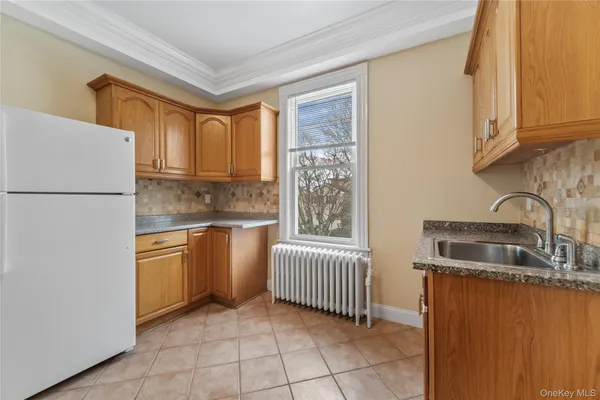 a kitchen with stainless steel appliances granite countertop a refrigerator sink and stove