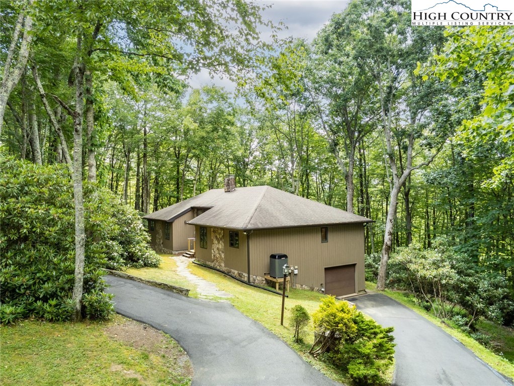 393 Trillium Ridge Boone, NC 28607 - Photo 1 of 50 a view of a house with a yard and sitting area