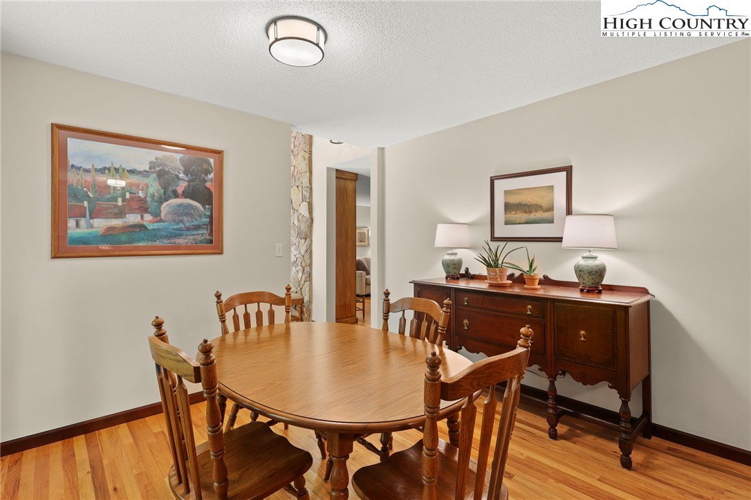 393 Trillium Ridge Boone, NC 28607 - Photo 20 of 50 a view of a dining room with furniture and wooden floor