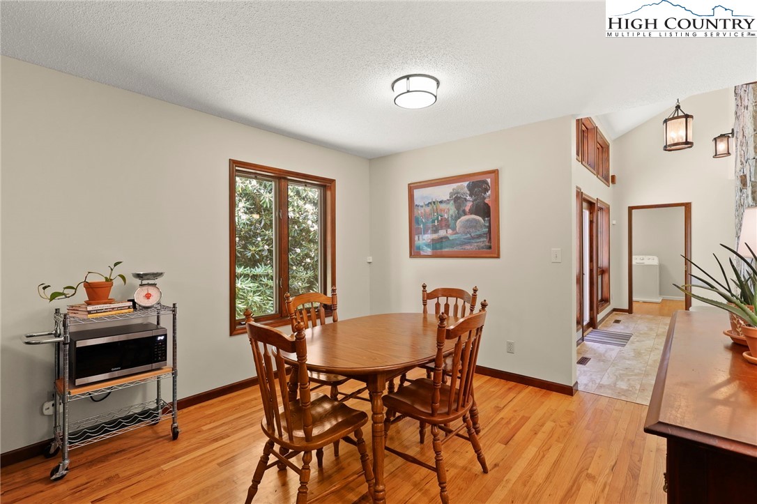 393 Trillium Ridge Boone, NC 28607 - Photo 21 of 50 a view of a dining room with furniture and wooden floor