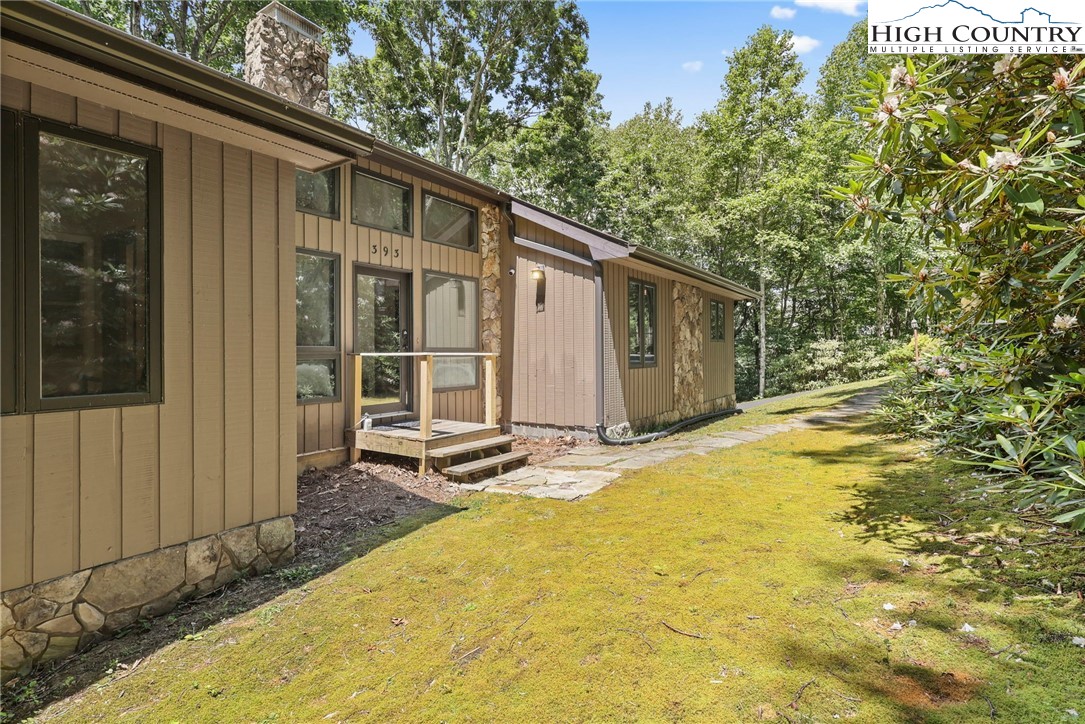 393 Trillium Ridge Boone, NC 28607 - Photo 7 of 50 a backyard of a house with basket ball court and outdoor kitchen