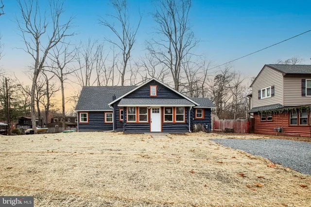 a view of a house with a yard covered in snow