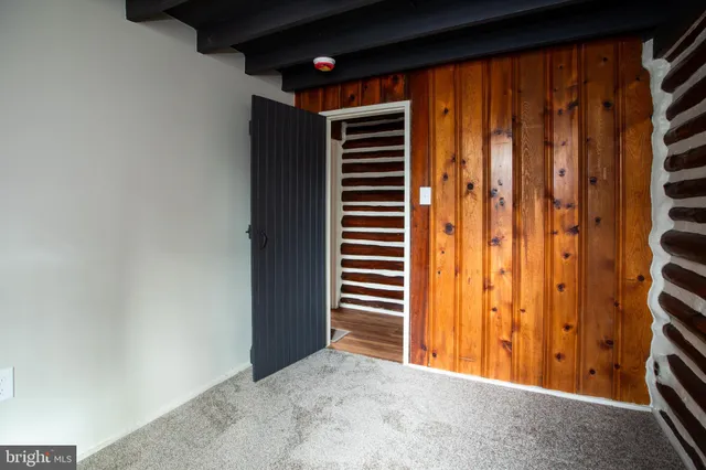 a view of a room with a wooden door